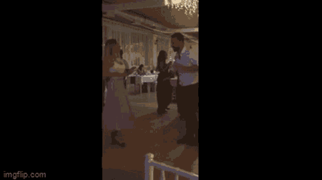 a group of people are dancing in a dark room with imgflip.com at the bottom of the screen