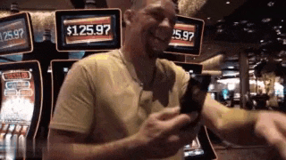 a man is standing in front of a slot machine with a screen that says $ 125.97