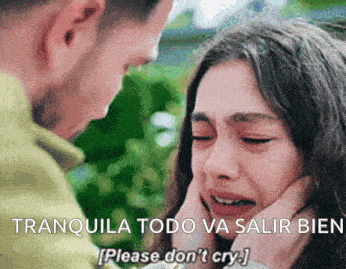 a woman is crying while a man holds her face and says " tranquila todo va salir bien please don 't cry "