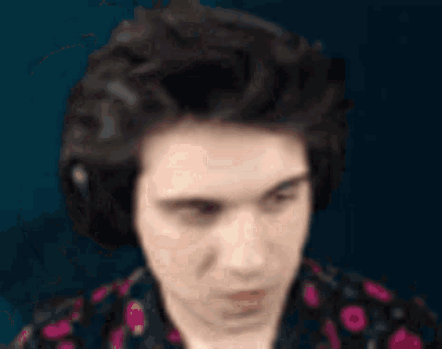 a close up of a man 's face with headphones on .