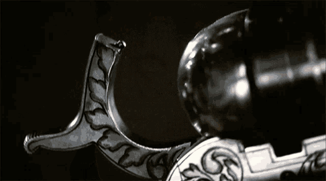 a black and white photo of a door knob with a swirl design on it