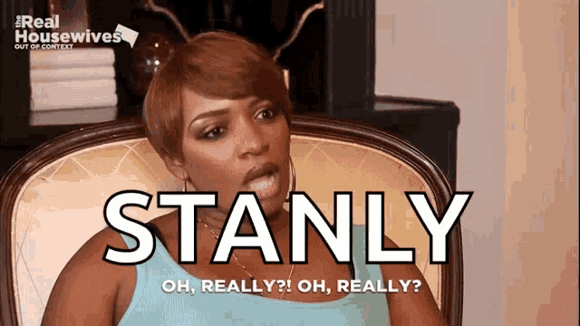 a woman is sitting in a chair with the words stanly on the screen behind her