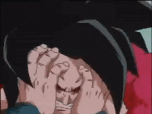 a person is covering their face with their hands .