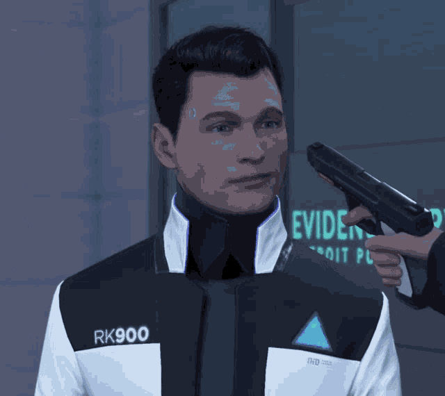 a man in a rk900 jacket is being held by someone holding a gun