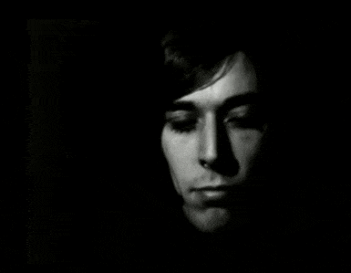 a close up of a man 's face in the dark .