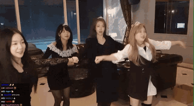 a group of young women are dancing in a room with a streamer 's name visible on the screen