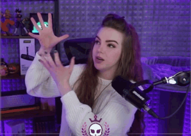 a woman stands in front of a shure microphone