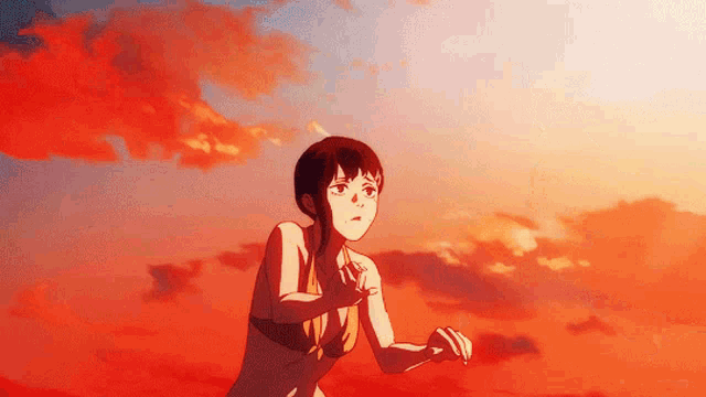 a girl in a bikini stands in front of a sunset sky