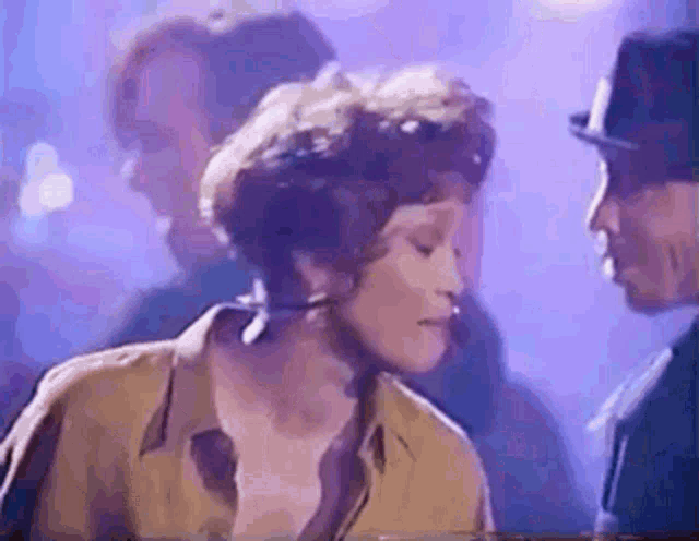 a woman is standing next to a man in a top hat .