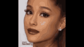 a close up of ariana grande 's face with a slight smile on her face .