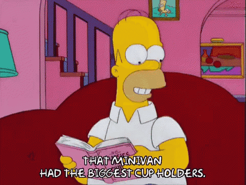 a cartoon of homer simpson reading a book which says that minivan had the biggest cup holders