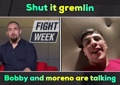 two men are talking in front of a sign that says " fight week "