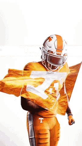 a football player wearing a helmet with the letter t on it