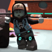 a lego character wearing a hoodie and hat is standing in a room .