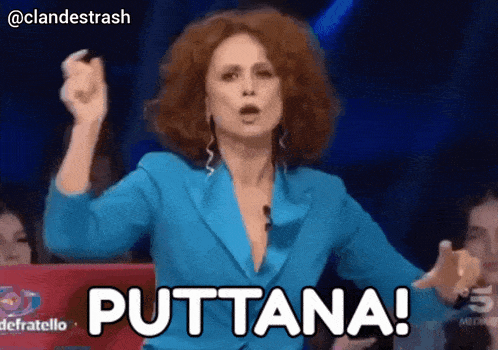 a woman in a blue jacket says puttana in front of a crowd