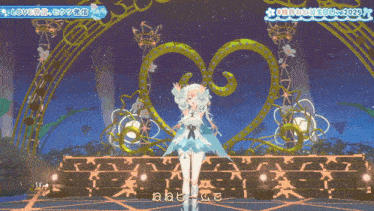 a girl in a white dress is on a stage in front of a sign that says love on it