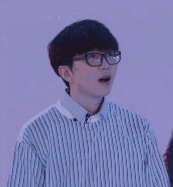 a person wearing glasses and a striped shirt