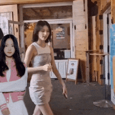 a woman with a bandage on her arm is walking down a street