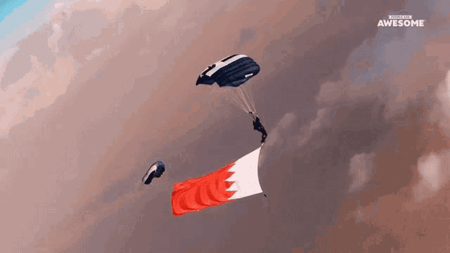 a group of parachutes are flying in the sky with the awesome logo in the background