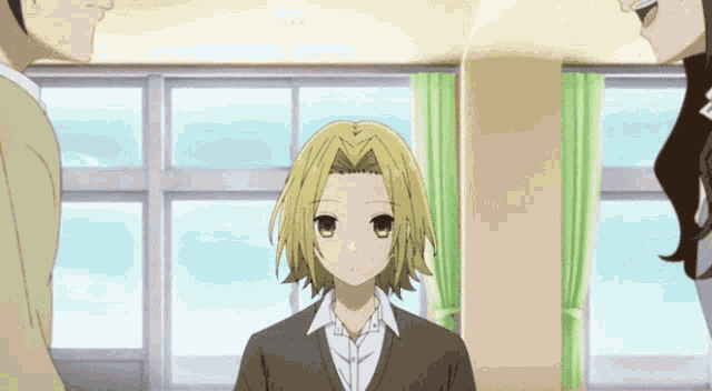 a girl with blonde hair is standing in front of a window in a room
