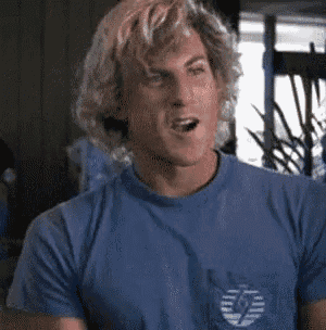 a man in a blue shirt is making a funny face .