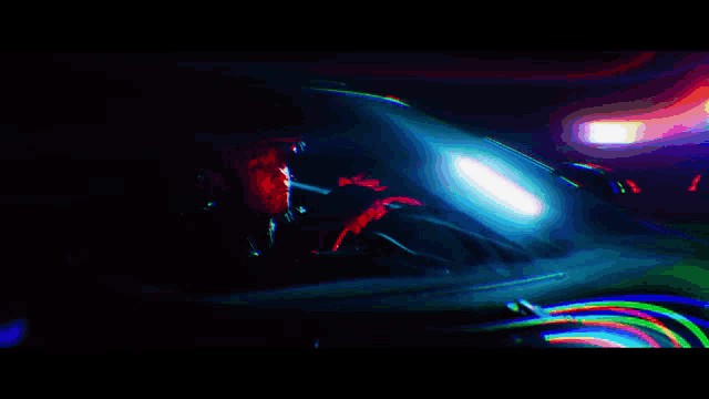 a man is sitting in the driver 's seat of a car at night .