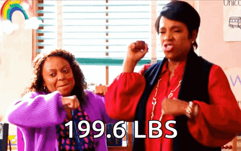 two women are flexing their muscles and one has 199.6 lbs on her arms