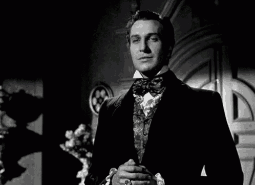 a black and white photo of a man in a tuxedo