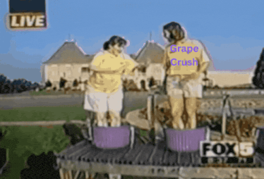 a couple of people standing in buckets with grape crush written on their shirt