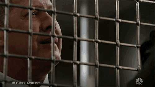 a man behind bars with #theblacklist on the bottom right