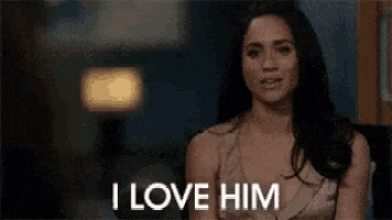 a woman is sitting in a chair with the words `` i love him '' written on her face .