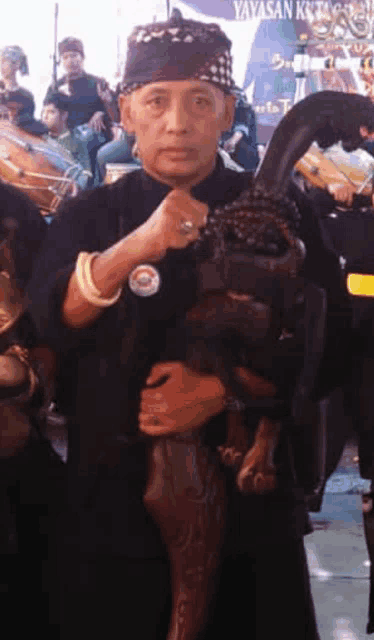 a man wearing a bandana holds a large sword in his hands