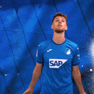 a man wearing a blue shirt with the word sap on the front