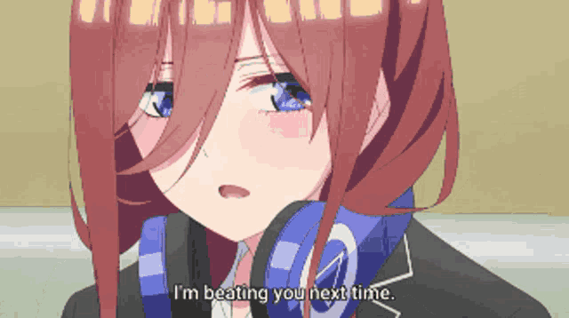 a girl with red hair and blue eyes is wearing headphones and saying i 'm beating you next time