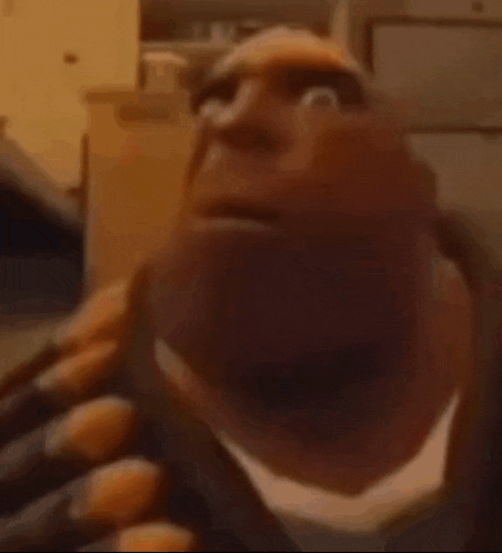 a close up of a cartoon character 's face with a bald head .