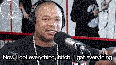 a man wearing headphones is talking into a microphone with the words now i got everything bitch i got everything