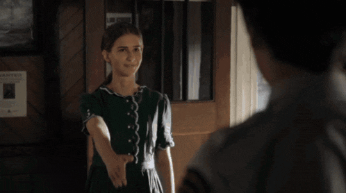a girl in a green dress says i 'm oliver to a man