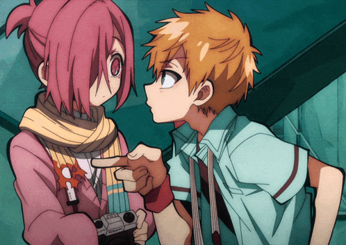 a boy and a girl are standing next to each other and the boy is pointing at the girl