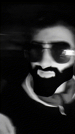 a close up of a man 's face with a beard and sunglasses on