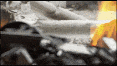 a blurred image of a fire with a few pieces of wood in it