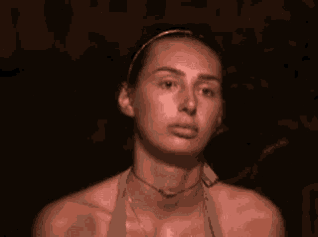 a woman is making a face and saying ok
