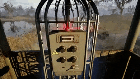 a close up of a control panel in a cage with a red light coming out of it .