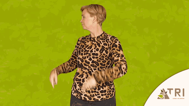 a woman in a leopard print shirt is pointing