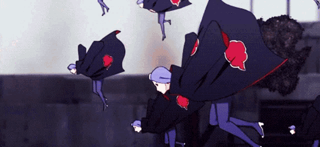 a group of people in capes with red hearts on them are flying through the air
