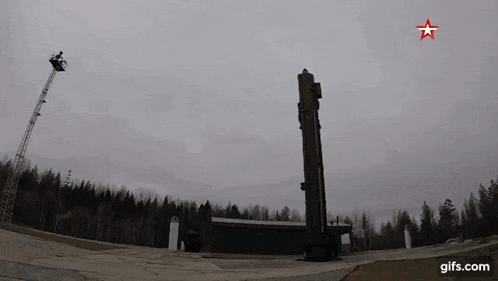 a rocket is being launched into the sky with a red star on it .