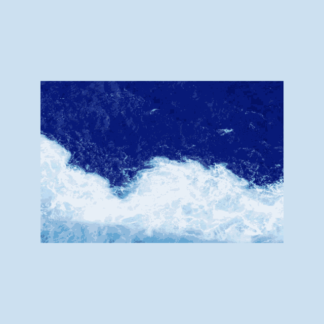 a picture of a blue ocean with waves and foam