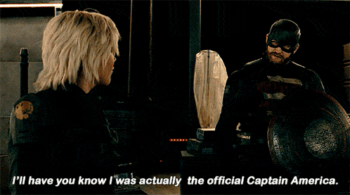 a woman talking to a man in a captain america uniform