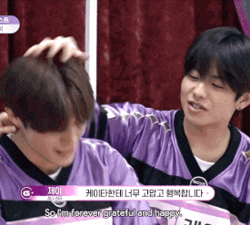 a man in a purple shirt talks to another man