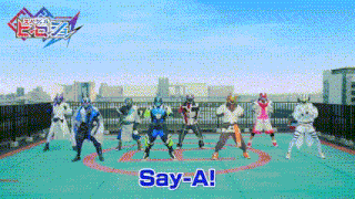 a group of superheros are dancing on a rooftop and they are saying say-a !