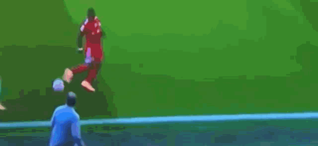 a man is kicking a soccer ball on the field